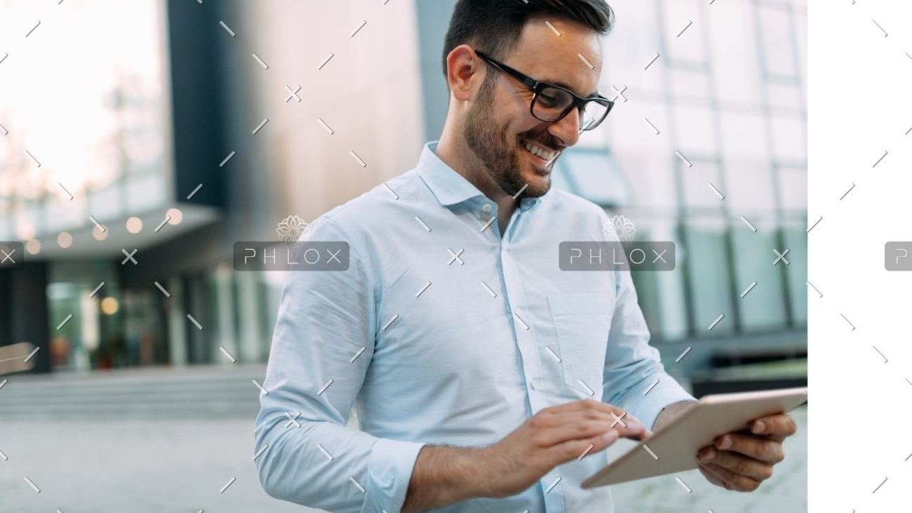 demo-attachment-815-portrait-of-businessman-in-glasses-holding-tablet-AWVHCJU